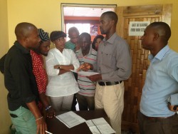 Oradian's Head of Implementation Onyeka Adibeli working with the staff of a Nigerian microfinance in