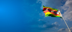 beautiful-national-state-flag-zimbabwe-blue-sky.jpg