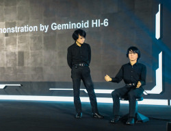 Japanese roboticist Hiroshi Ishiguro and his robot twin, Geminoid HI-1, wow DeepFest audience.jpg