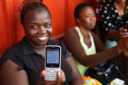 a nurse displays her text notification  of mobile money in Freetown @ UNDP Sierra Leone.JPG