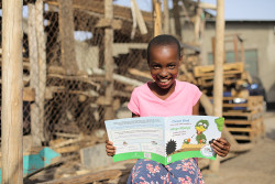 Girl with Ubongo Kids printed book.jpg
