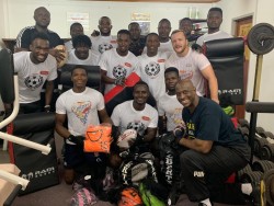 Mr Herbert Mensah, Prseident of Ghana Rugby, with Ghana rugby players during a gym session in Accra 
